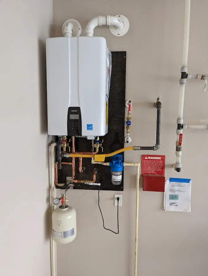 Professional plumber installing copper piping in a Woods Creek home